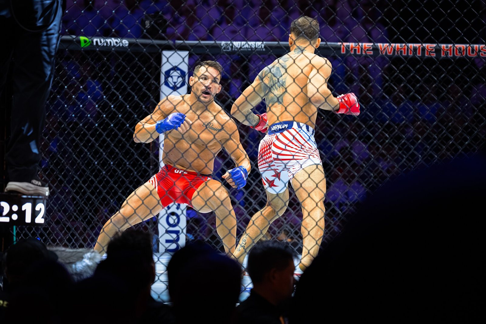 Бой в октагоне UFC: два бойца ММА обмениваются ударами